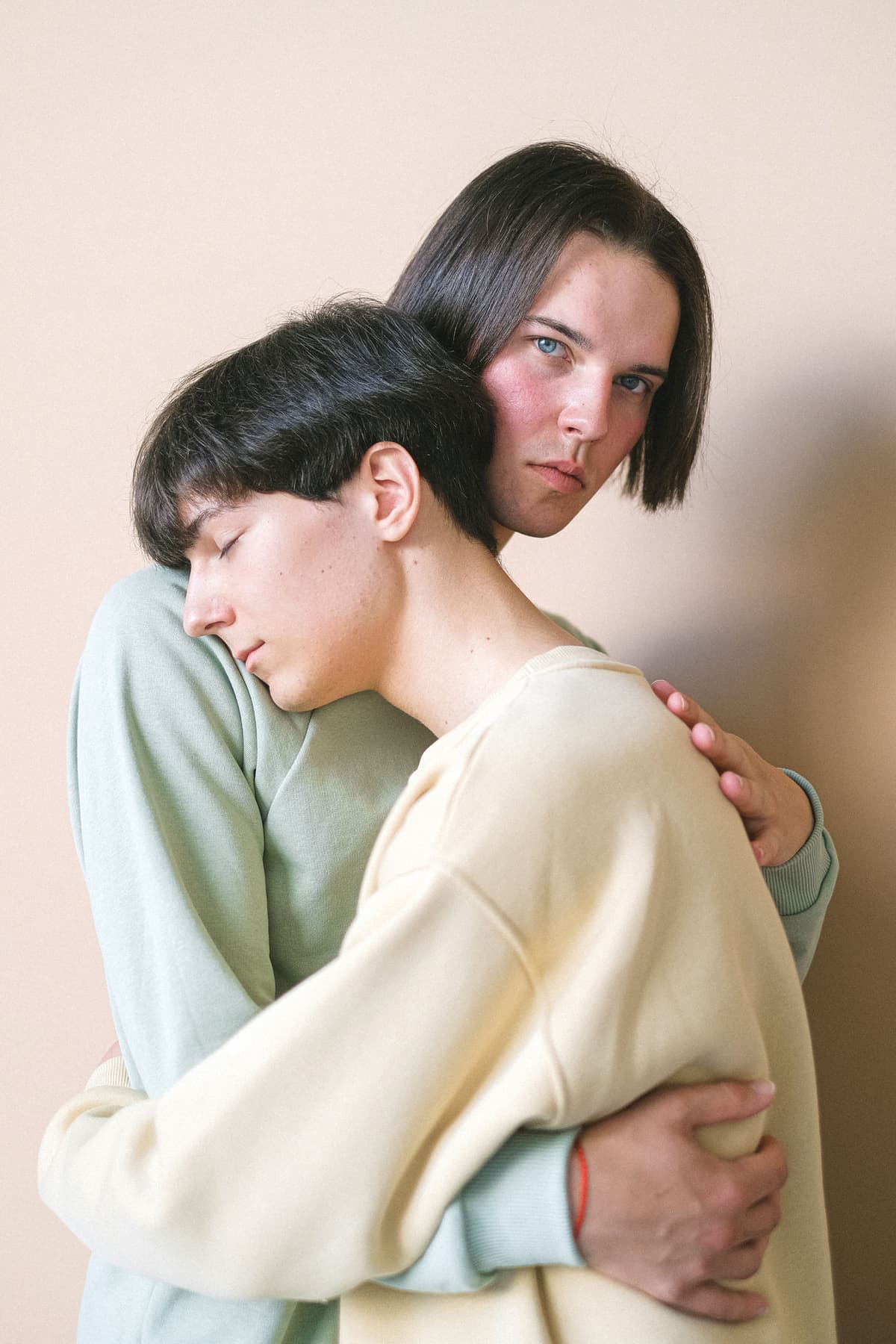 Two people embracing in a quiet room.